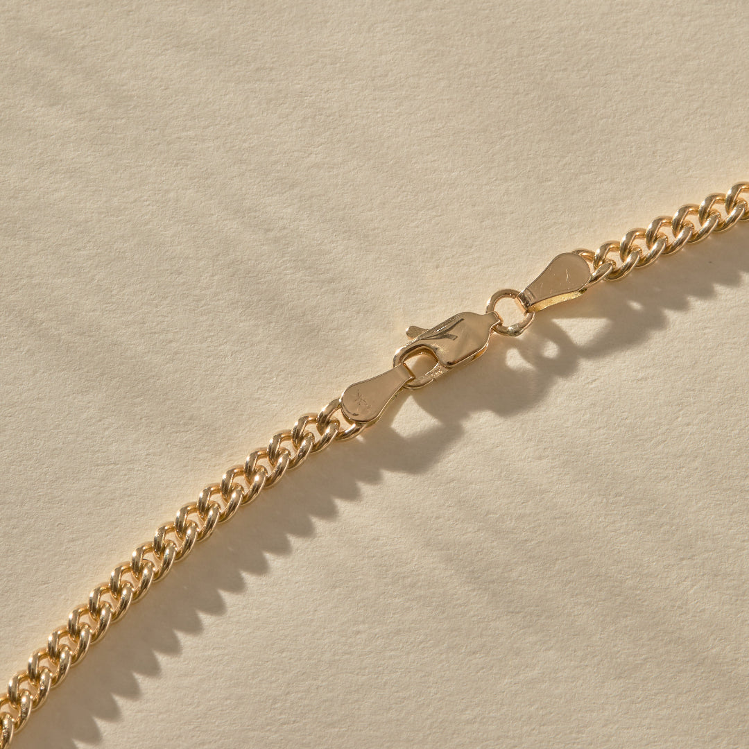 Gold chain on a beige background