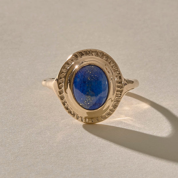An elegant gold ring featuring an oval-shaped Lapis Lazuli stone set in a solid gold setting, with aRecycled 10k, 14k, or 18k gold option.