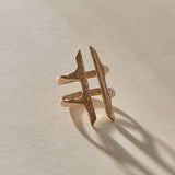 Akash Shield Statement Ring in recycled bronze at an angle, showing the carved shield bars and open design.