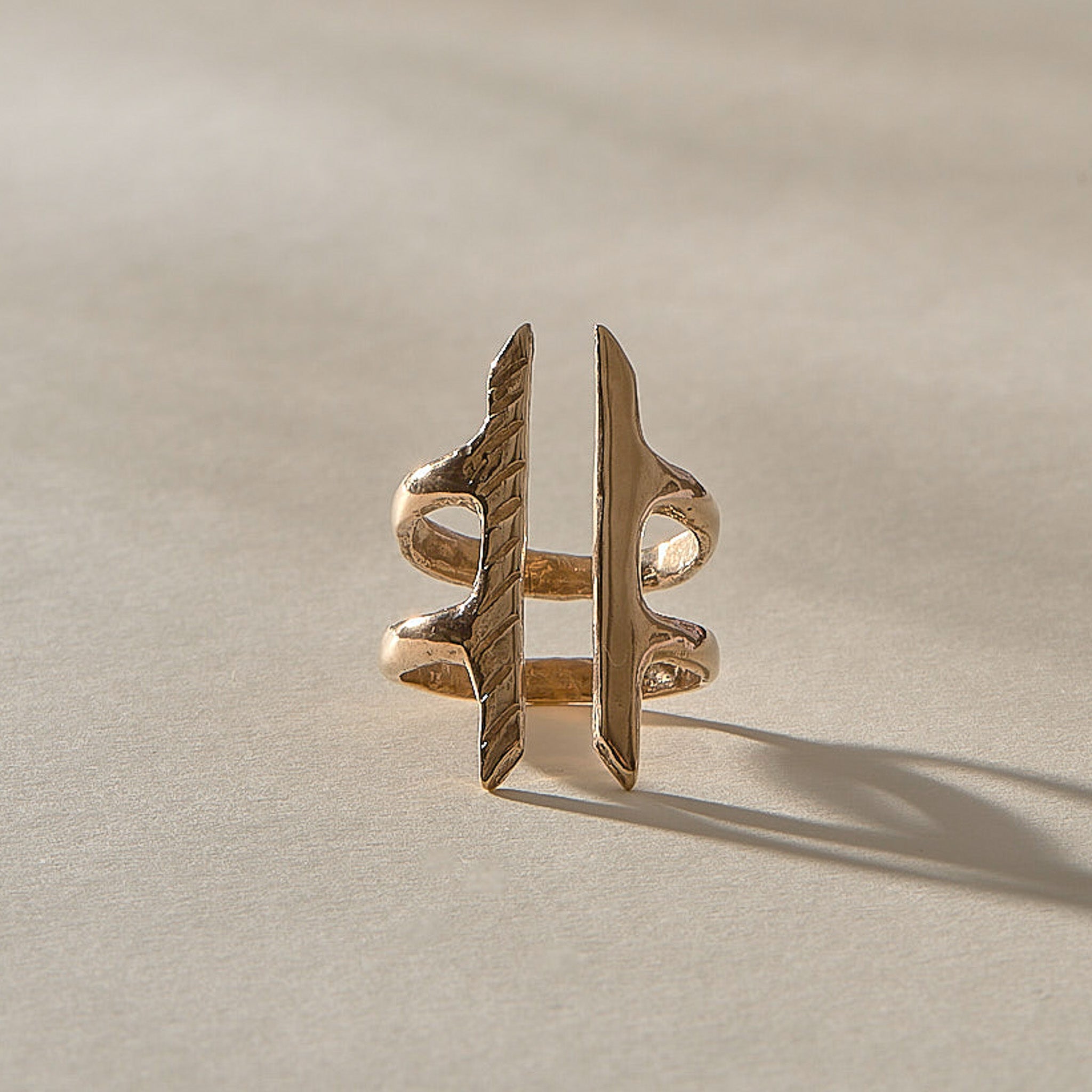 Akash Shield Statement Ring in recycled bronze from the front, two carved bars joined by a double band.