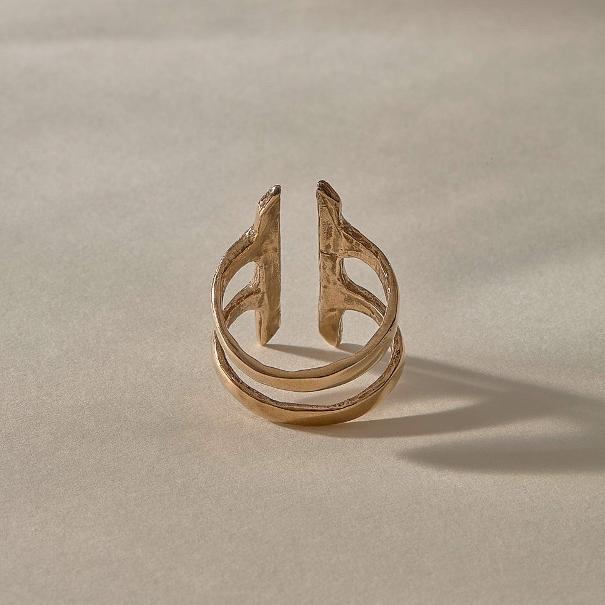 Akash Shield Statement Ring in recycled bronze from the side, showing the open double band.