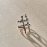 Akash Shield Statement Ring in recycled sterling silver at an angle, showing the carved shield bars and open design.