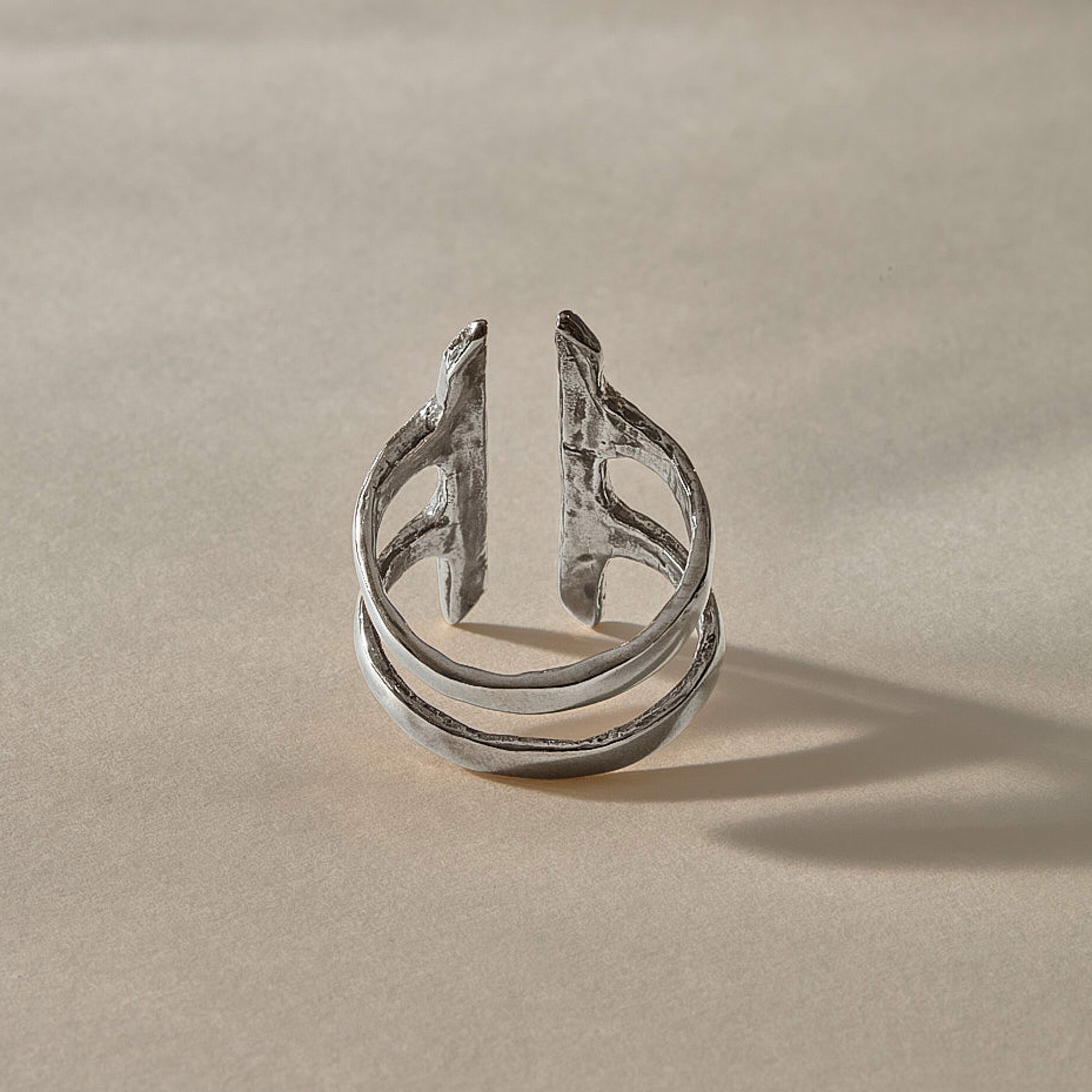 Akash Shield Statement Ring in recycled sterling silver from the side, showing the open double band.
