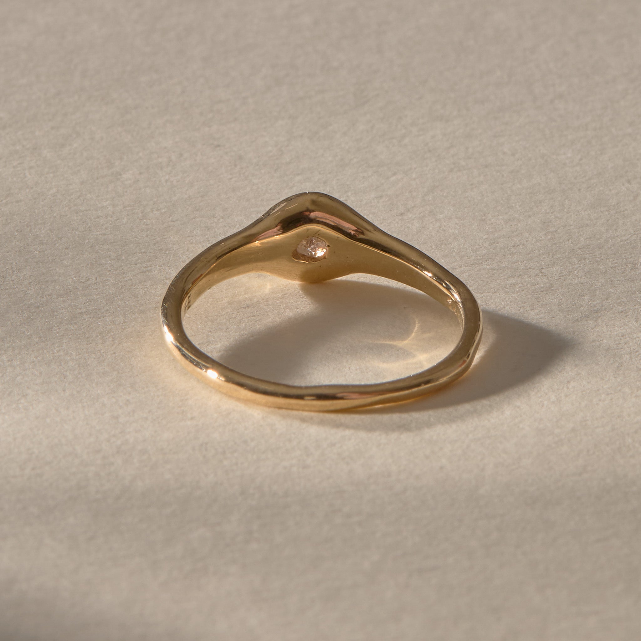 Ama Champagne Diamond Ring in gold from behind, showing the smooth organic band.