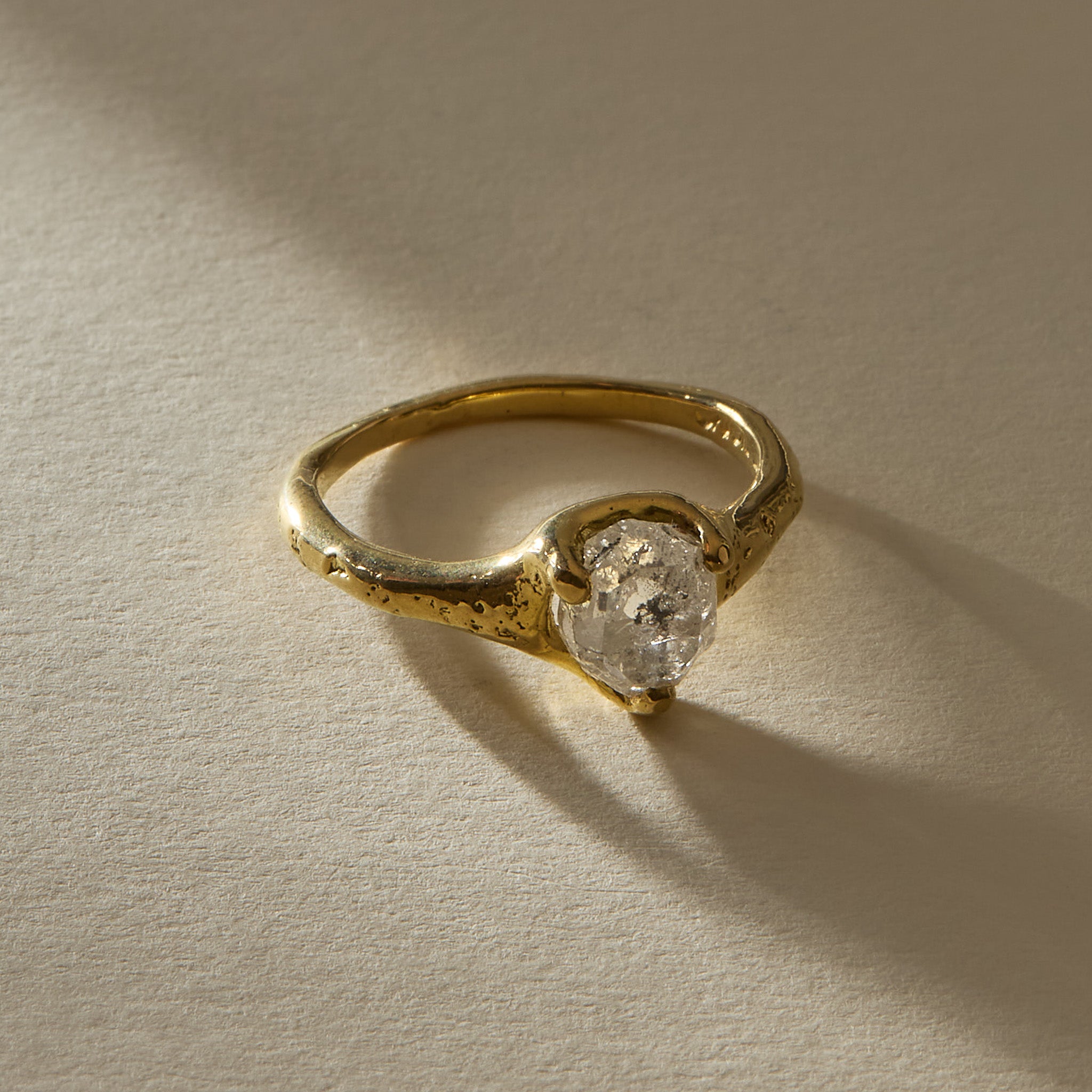 Amara Ring in 18k recycled gold with a 2.28ct polished raw Canadian diamond and a molten organic band, in soft sunlight.