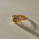 Ambre Ring in 14k gold at an angle, with the smooth band sweeping into the champagne diamond setting.