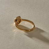 Ambre Ring in 14k recycled gold from behind, with the band curving up into the diamond setting.