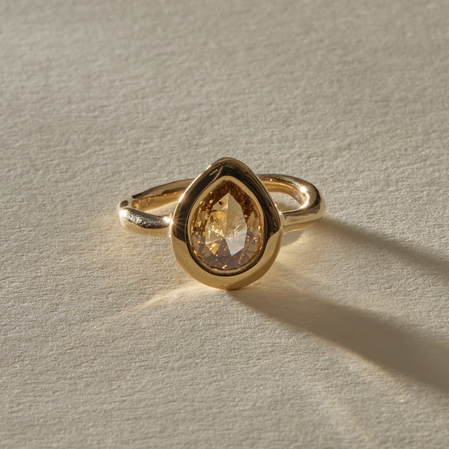 Aurum Pear Diamond Ring from the front, showing the rose cut facets and organic bezel.