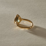 Aurum Pear Diamond Ring from the side, showing the soft bezel and slim gold band.