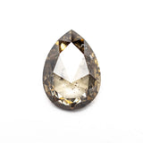 Close up of the champagne salt and pepper pear rose cut diamond showing its natural inclusions.