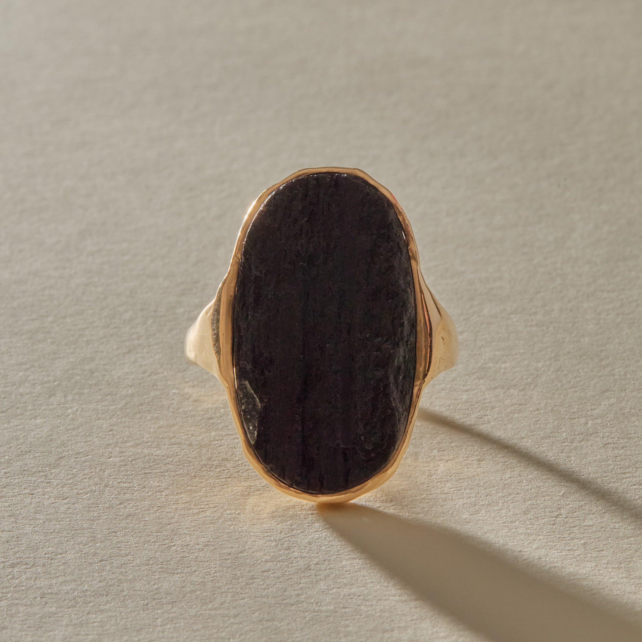 Black Tourmaline Amulet Ring XIX, a one of a kind raw black tourmaline set in an open-back 10k recycled gold double band.