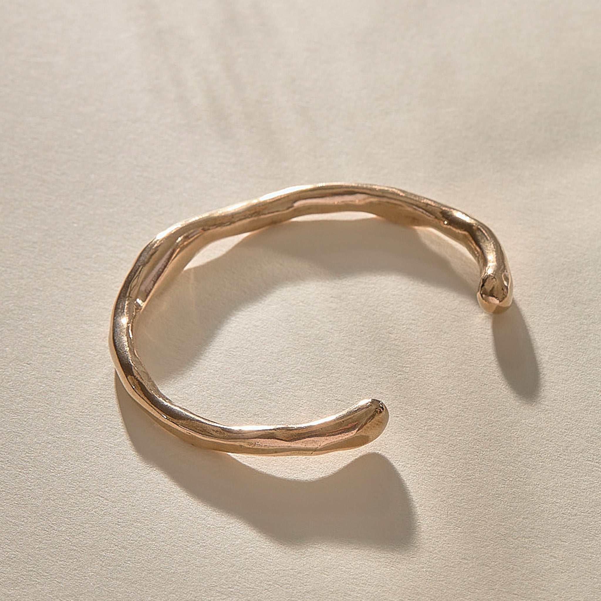 Bone Cuff Bracelet in recycled bronze, a sculptural open cuff with an organic, bone-like form.