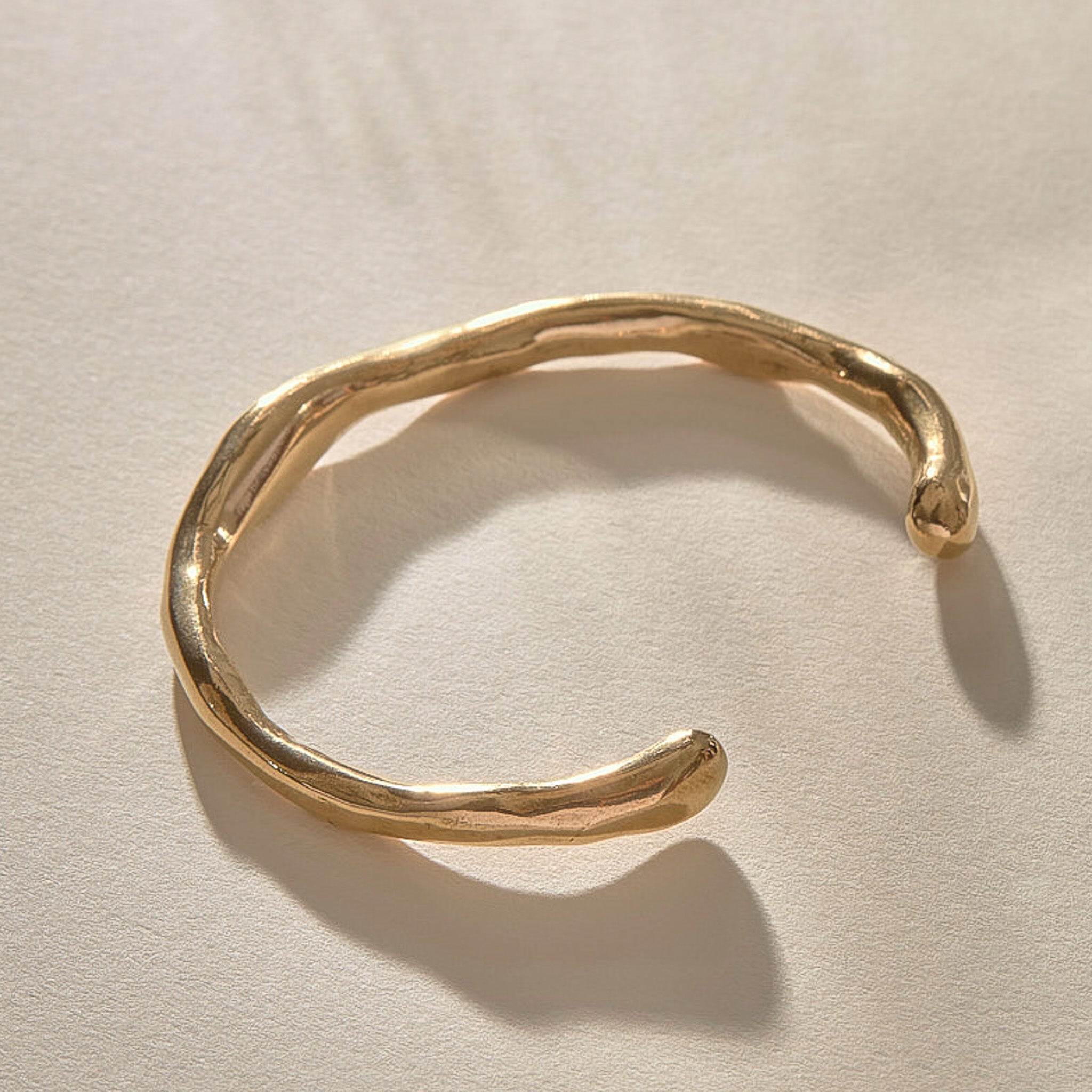 Bone Cuff Bracelet in recycled gold, a sculptural open cuff with an organic, bone-like form.