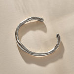Bone Cuff Bracelet in sterling silver from the front, the band thickening and thinning along its curve.