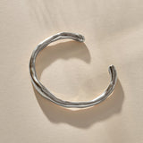 Bone Cuff Bracelet in sterling silver from the front, the band thickening and thinning along its curve.