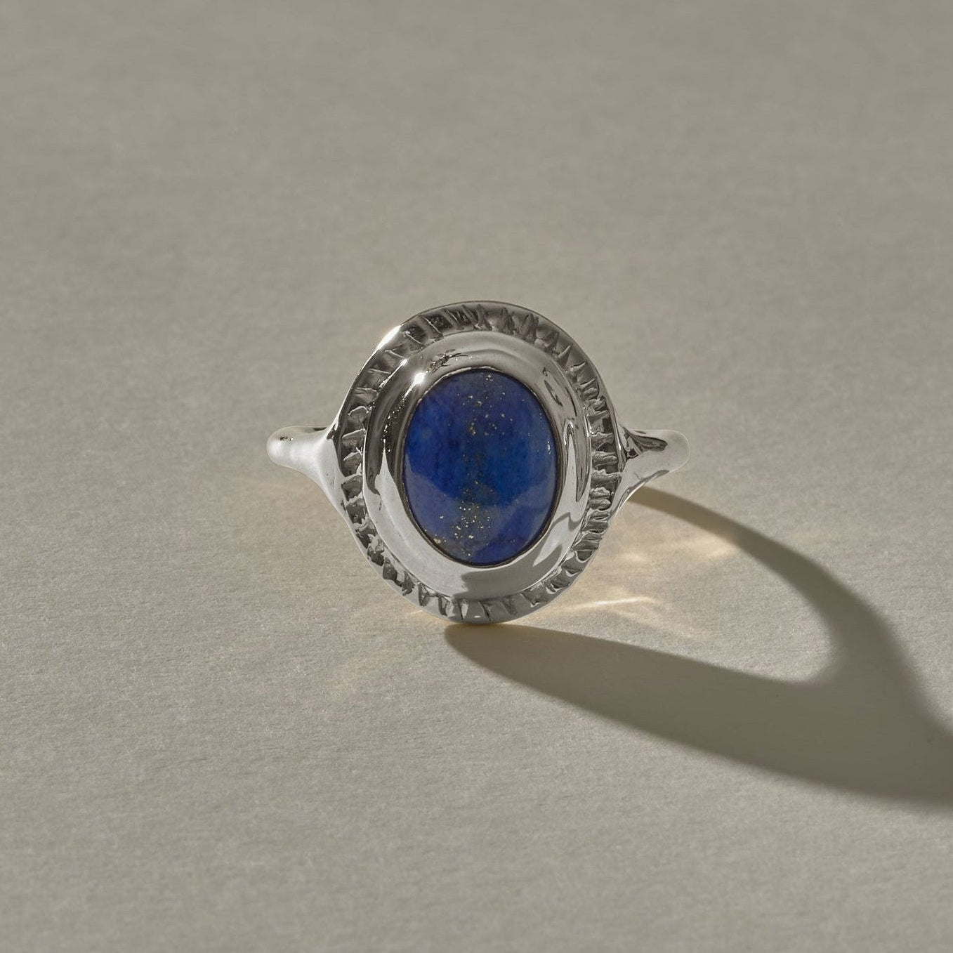 Cleo Lapis Lazuli Amulet Ring in sterling silver from the front, showing the deep blue lapis with golden flecks.