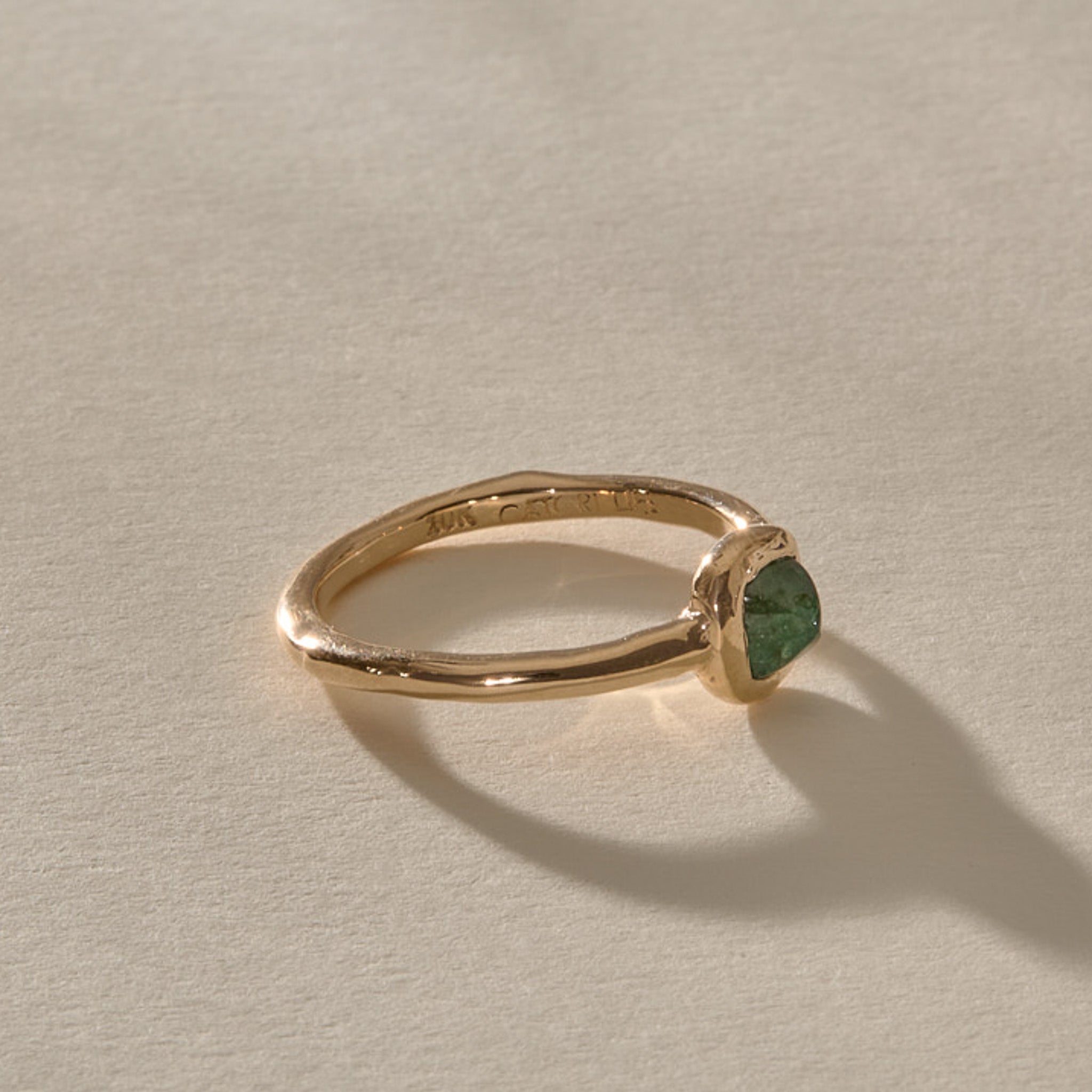 Cosmos Emerald Ring in solid recycled gold from the side, showing the slim, gently curved band.