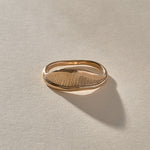 Devotions Wave Ring in recycled bronze, showing the fine carved lines across the wave.