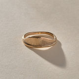 Devotions Wave Ring in recycled bronze, showing the fine carved lines across the wave.