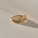 Devotions Wave Ring in solid recycled gold at an angle, showing the textured wave face.