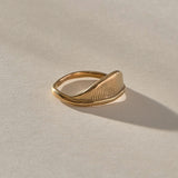 Devotions Wave Ring in solid recycled gold at an angle, showing the textured wave face.