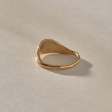 Devotions Wave Ring in solid recycled gold from the front, showing the smooth rising band.