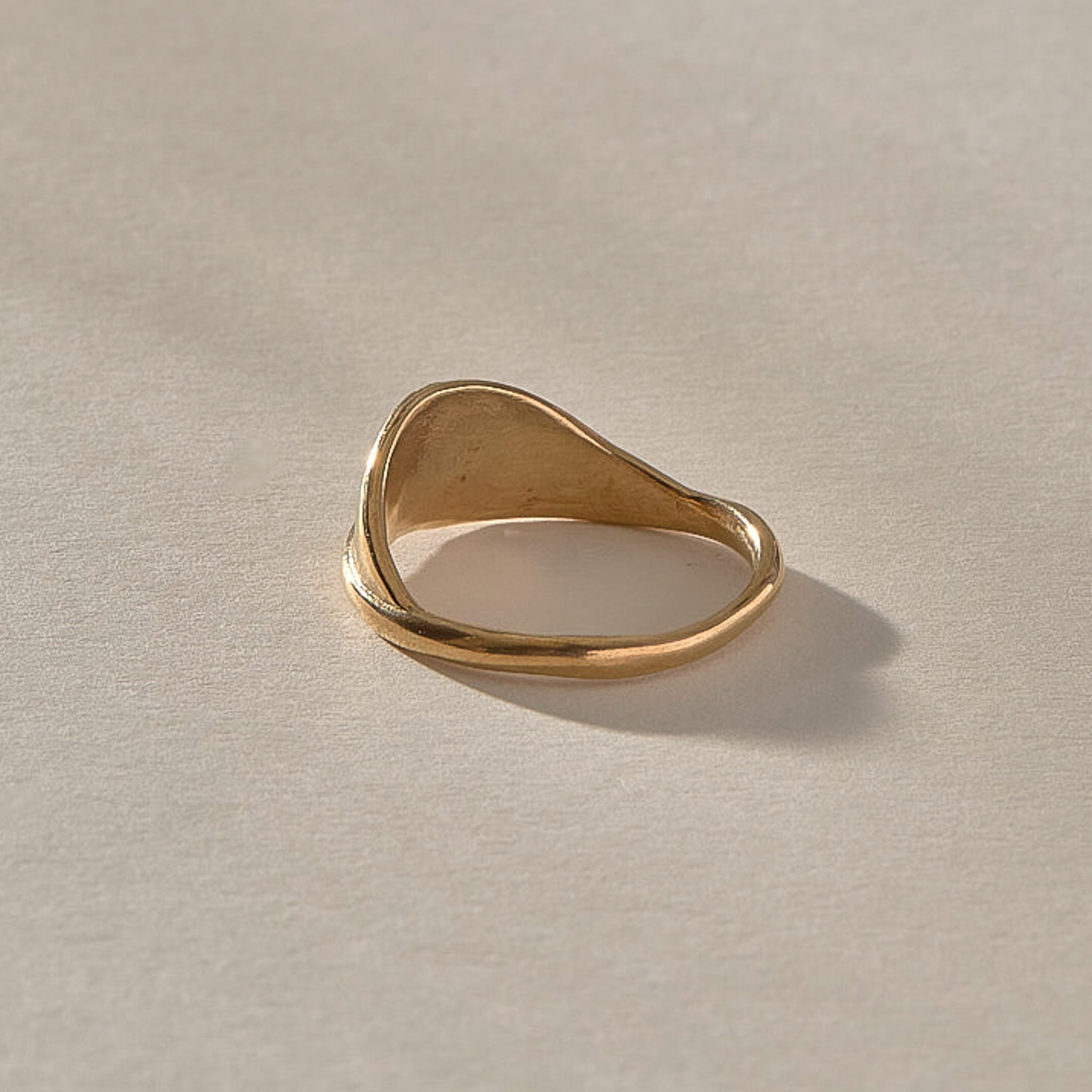 Devotions Wave Ring in solid recycled gold from the front, showing the smooth rising band.
