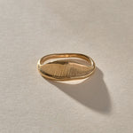 Devotions Wave Ring in solid recycled gold from the side, showing the fine carved lines.