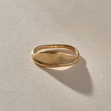 Devotions Wave Ring in solid recycled gold from the side, showing the fine carved lines.