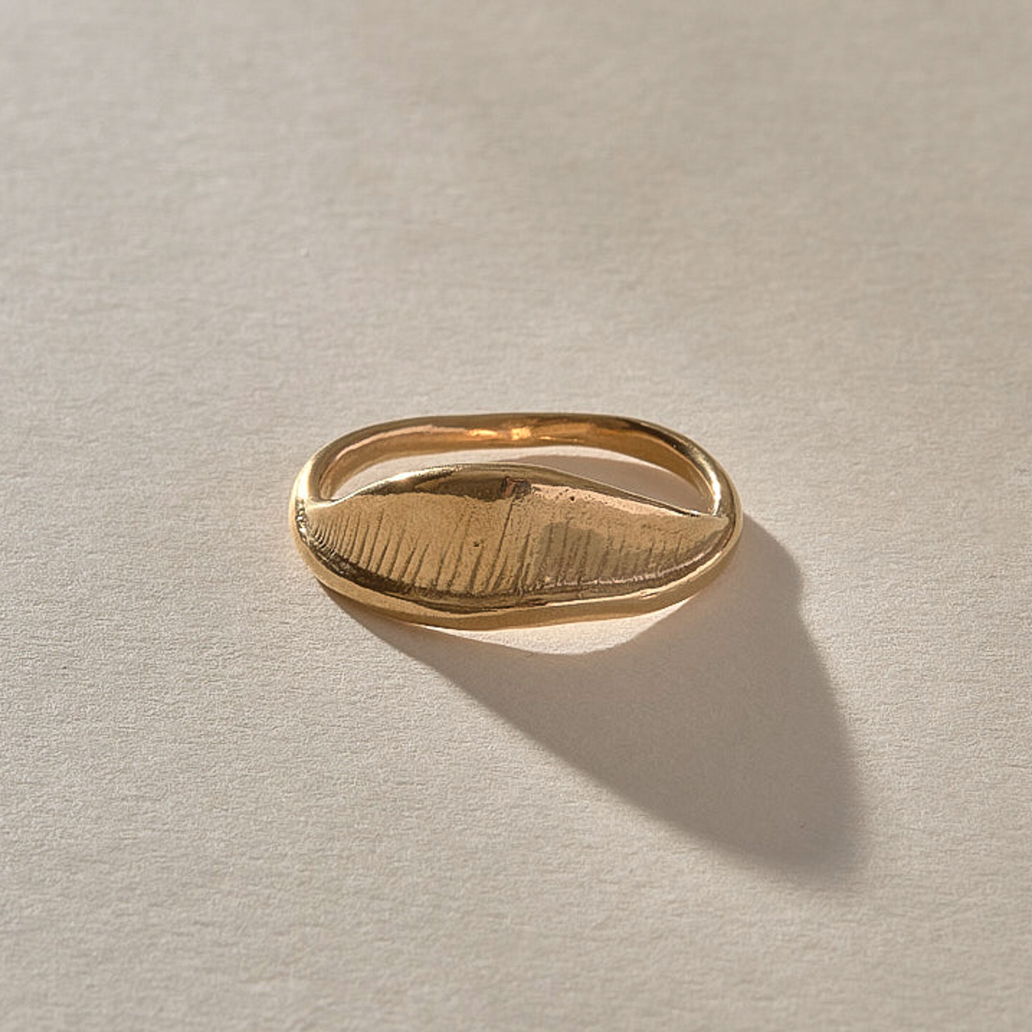 Devotions Wave Ring in solid recycled gold from the side, showing the fine carved lines.