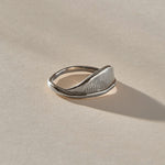 Devotions Wave Ring in recycled sterling silver at an angle, showing the fine carved lines across the wave.