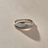 Devotions Wave Ring in recycled sterling silver from the side, showing the textured wave face.