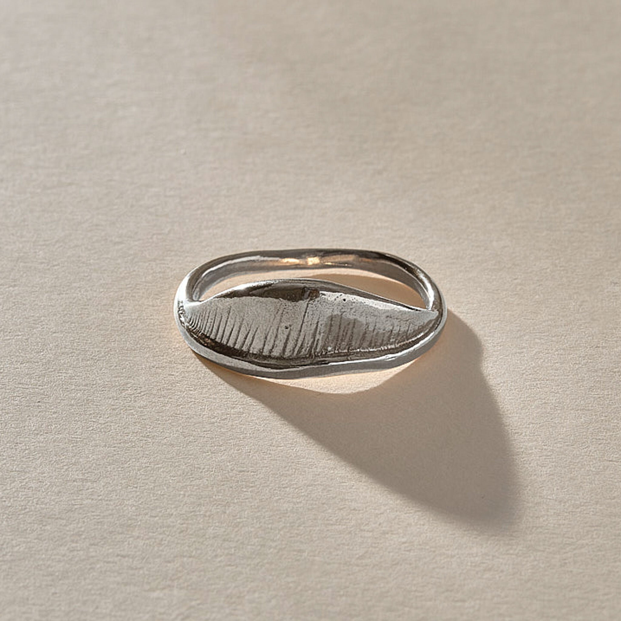 Devotions Wave Ring in recycled sterling silver from the side, showing the textured wave face.