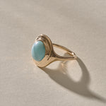 Elysian Larimar Signet Ring in solid recycled gold at an angle, showing the round larimar cabochon.