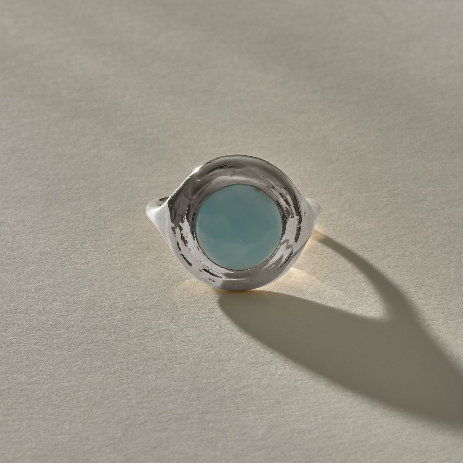 Elysian Larimar Signet Ring in recycled sterling silver from the front, a round larimar stone in a textured signet setting.