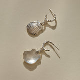 Elysian Shell Hoop Earrings in sterling silver, one shell turned to show its smooth inside.