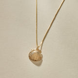 Elysian Shell Necklace in gold, a close view of the ribbed scallop shell pendant.