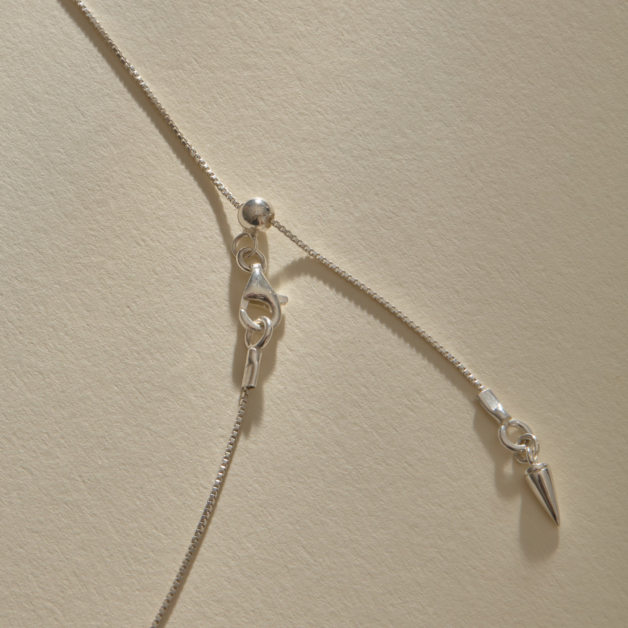 Clasp and adjustable box chain of the Elysian Shell Necklace in sterling silver.