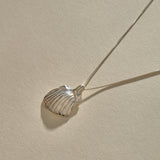 Elysian Shell Necklace in sterling silver, the ribbed scallop shell pendant at an angle.
