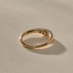 Eros Five-Stone Champagne Diamond Band in solid recycled gold from the back at an angle, showing the smooth inner band.
