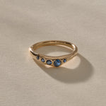 Eros Five-Stone Sapphire Band in solid recycled gold, five deep blue sapphires set across an organic band.