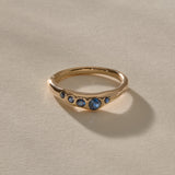 Eros Five-Stone Sapphire Band in solid recycled gold, five deep blue sapphires set across an organic band.