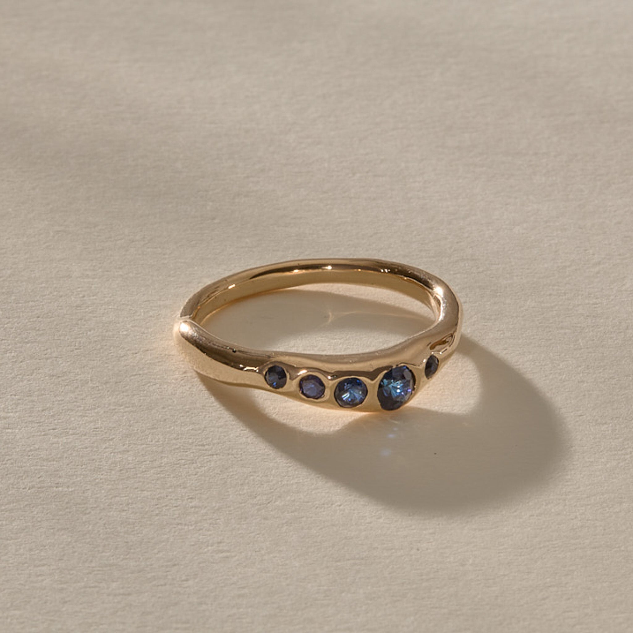 Eros Five-Stone Sapphire Band in solid recycled gold from the side, showing the softly undulating band.