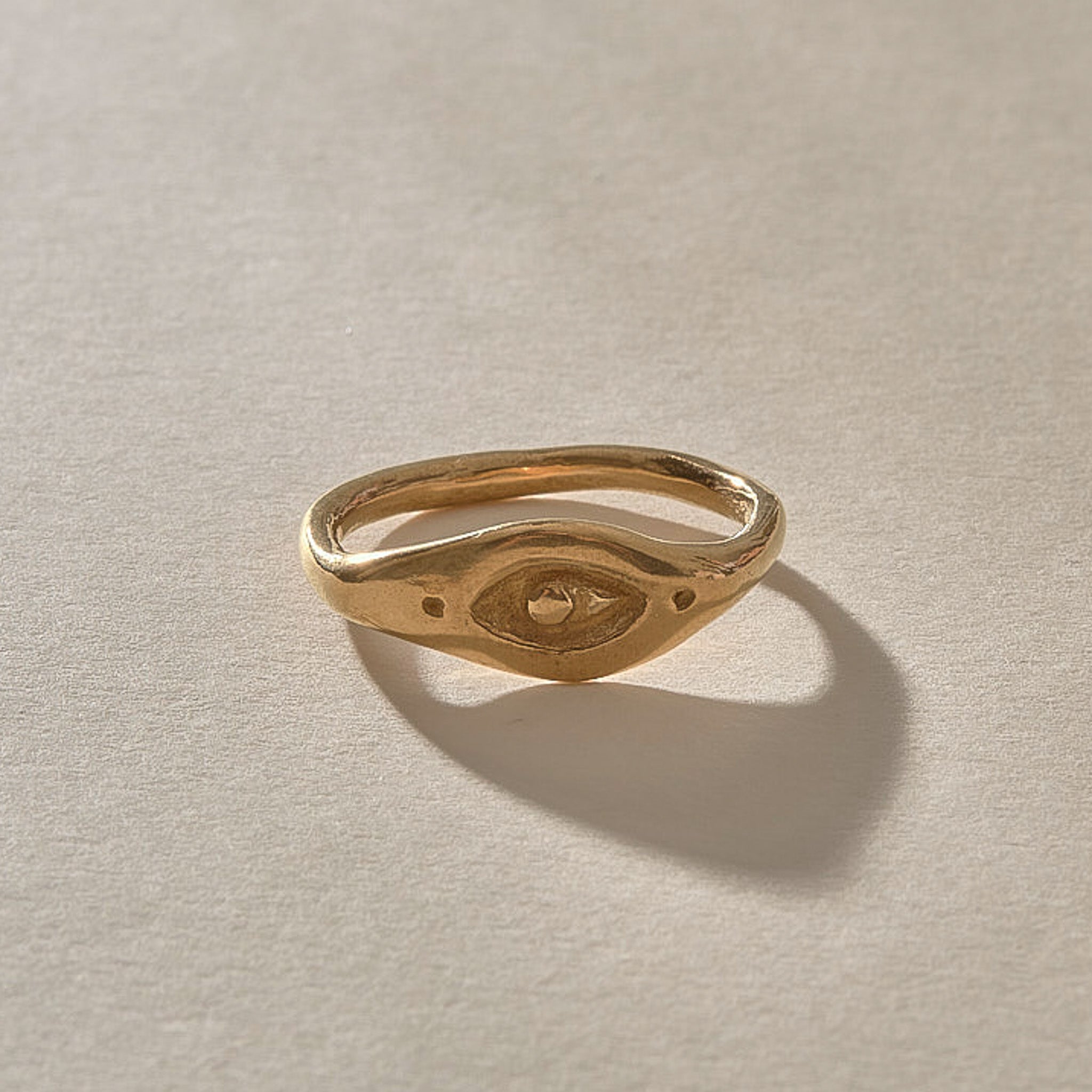 Evil Eye Protection Ring in solid recycled gold from the front, showing the carved eye.