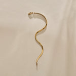 Fehu Herringbone Chain Bracelet in gold laid in an S curve.
