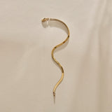Fehu Herringbone Chain Bracelet in gold laid in an S curve.