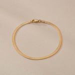 Fehu Herringbone Chain Bracelet in 14k solid recycled gold, a 2.5mm flat herringbone chain with lobster clasp.