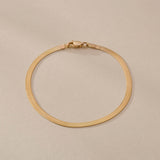 Fehu Herringbone Chain Bracelet in 14k solid recycled gold, a 2.5mm flat herringbone chain with lobster clasp.