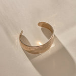 Guardian Hammered Cuff in bronze at an angle, showing the open back and textured surface.