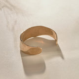 Guardian Hammered Cuff in bronze from the side, showing its wide, flowing band.